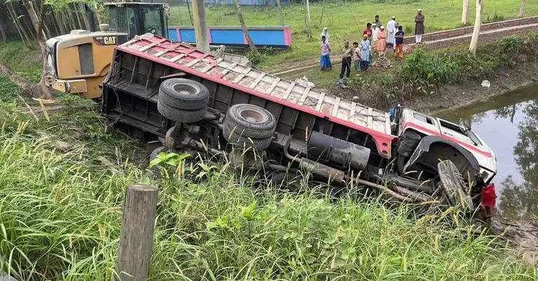 সংঘর্ষে রাস্তার পাশে উল্টে থাকা সিমেন্টবাহী ট্রাক